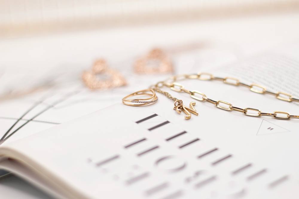 Gold jewelry resting on the pages of an open book